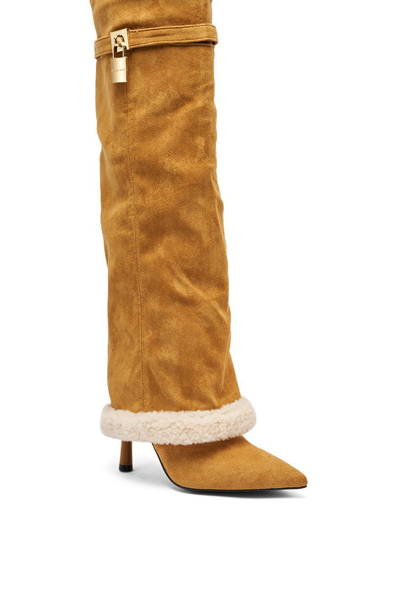 The AZALEA WANG RACHANA TAN SHERPA STILETTO BOOT features tan faux suede, a pointed toe, low stiletto heel, shearling trim at the foot, and a gold buckle detail near the knee.