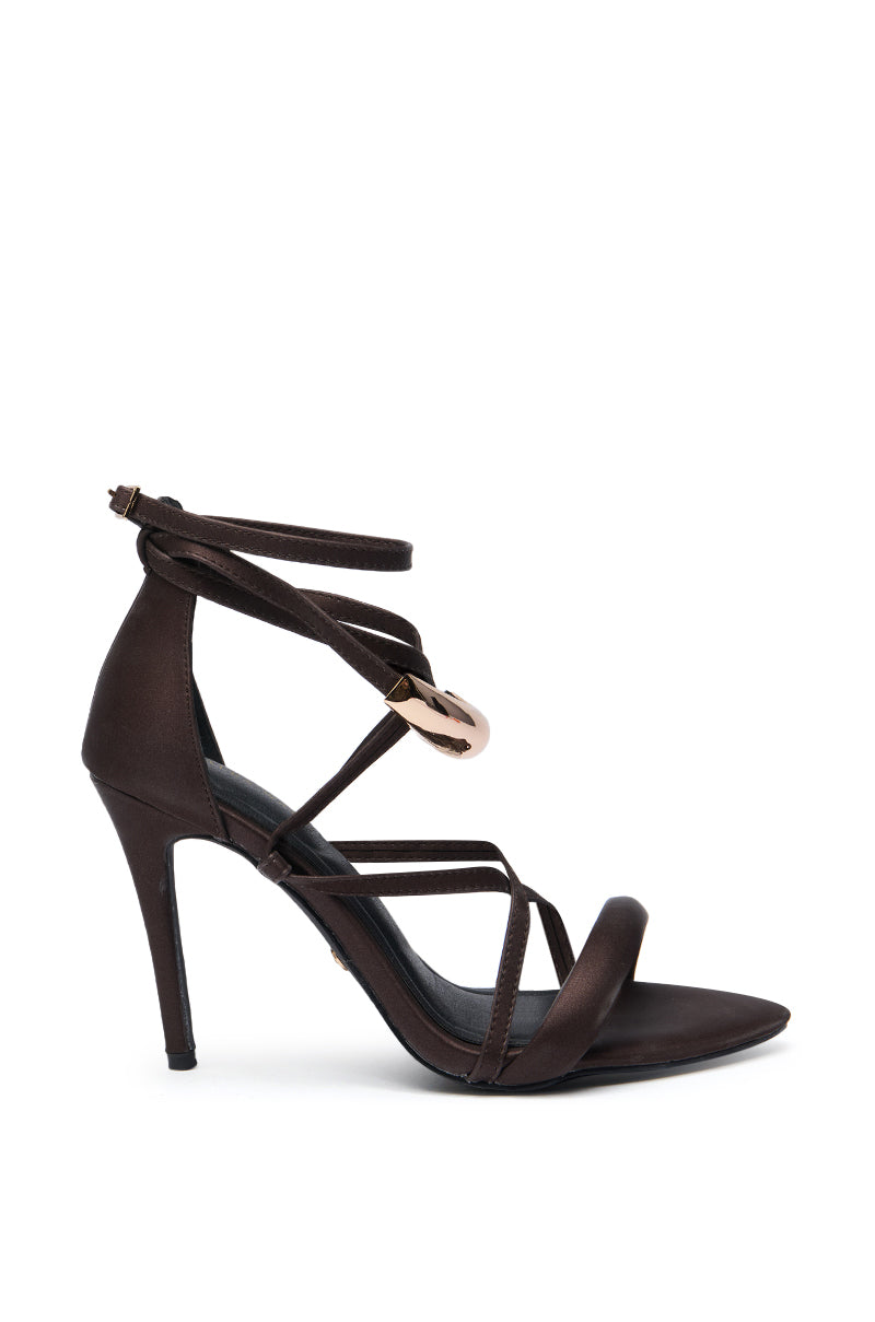 The AZALEA WANG RADHA CHOCOLATE METAL EMBELLISHED SANDAL features a stiletto heel, multiple thin straps, gold-accented ankle wrap, open toe, and a back zip closure. 4