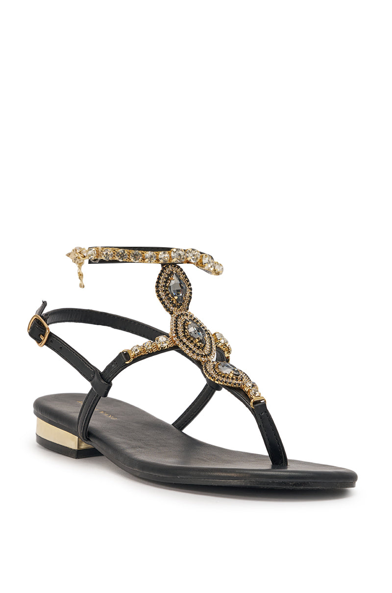 The AZALEA WANG RAFEE Black Rhinestone Embellished Flat Strap Sandal features black faux leather, intricate gold and rhinestone embellishments on the straps and ankle, offering an elegant, ornate look perfect for any occasion. 5