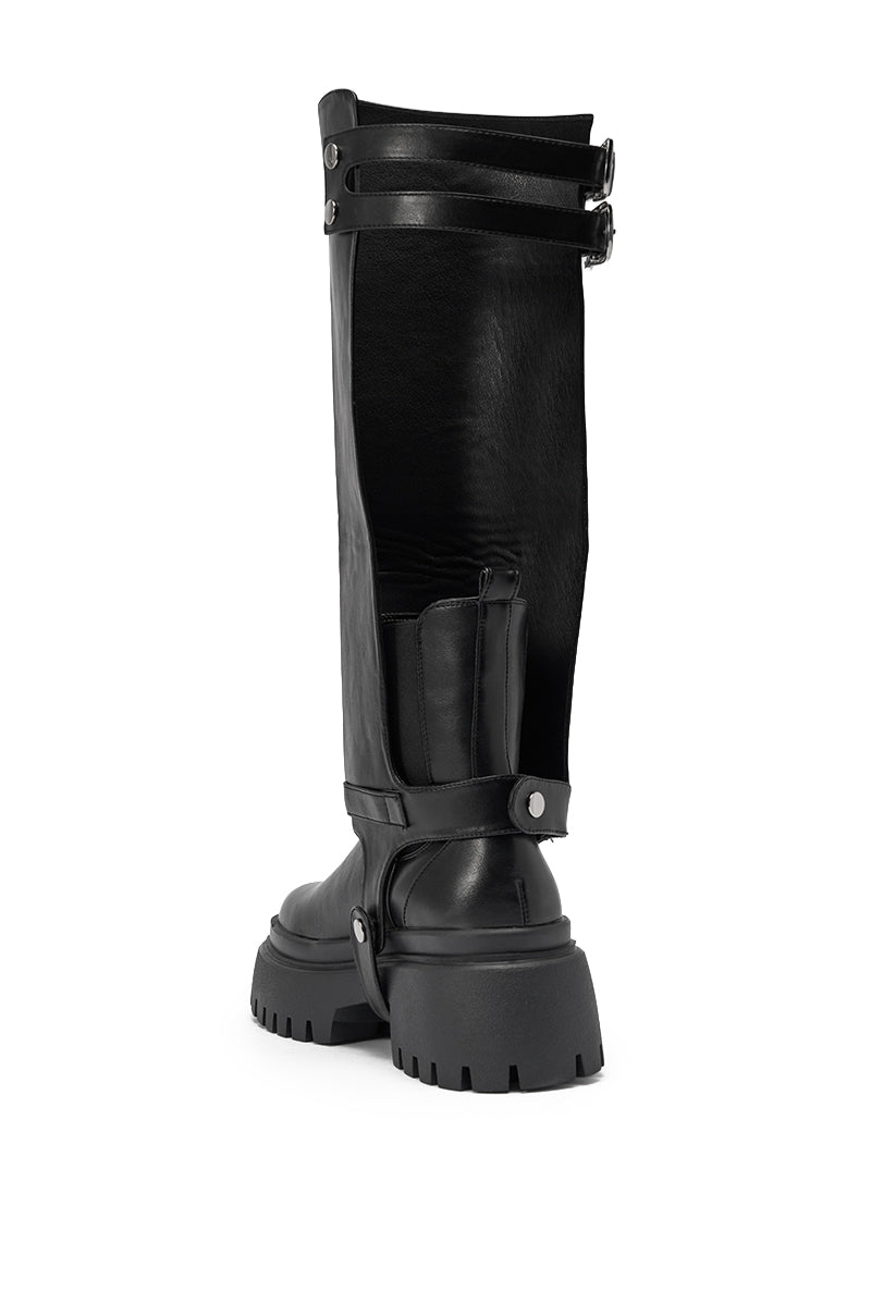 The AZALEA WANG RAMPAGE BLACK DISTRESSED TWO PIECE COMBAT BOOT is shown from the rear, featuring a knee-high shaft, chunky platform lug sole, leather straps, and metal buckles on a white background. 9