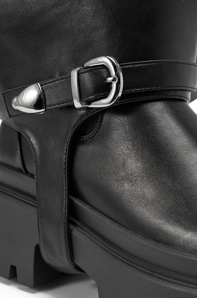 Close-up of the AZALEA WANG RAMPAGE BLACK DISTRESSED TWO PIECE COMBAT BOOT, showcasing its black faux leather, platform lug sole, decorative silver buckle, and ankle strap details with visible texture and shine. 11