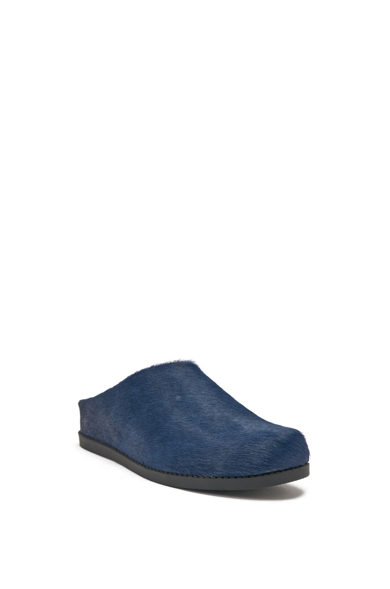 The AZALEA WANG RAMSES NAVY SLIP ON FLAT is a single, navy mule shoe made from genuine calf hair with a textured, furry surface and flat black sole, shown against a white background. 4