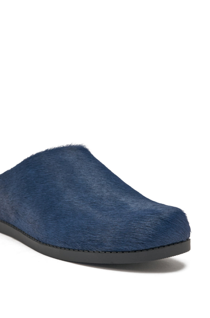 A close-up of the AZALEA WANG RAMSES NAVY SLIP ON FLAT, featuring genuine calf hair with a textured fur-like finish and a black flat sole, displayed against a white background. 6