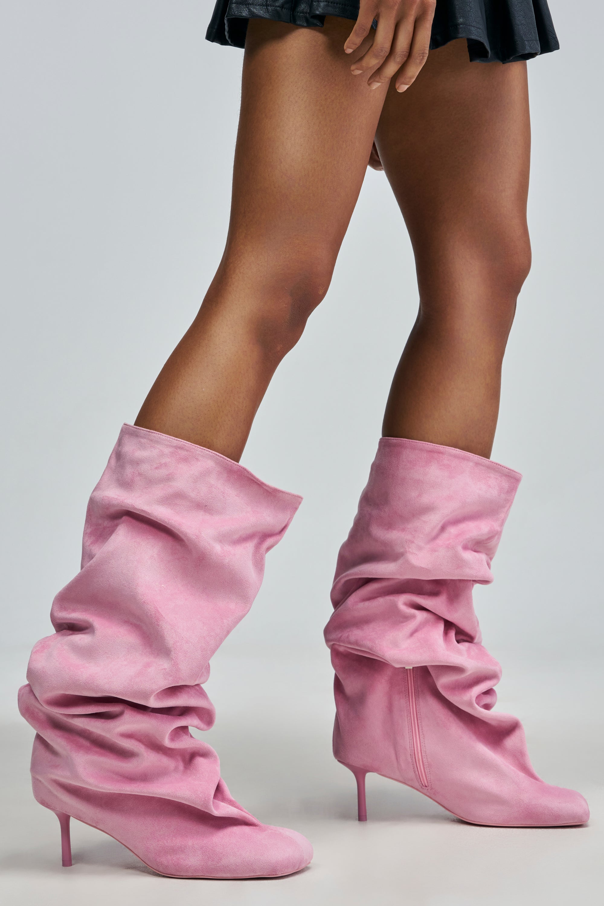 Person wearing pink slouchy suede stiletto knee-high AZALEA WANG RANDALL PINK SUEDE STILETTO BOOTs.