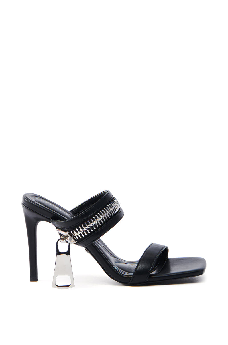 The AZALEA WANG RAQUEL BLACK LARGE ZIPPER STRAP STILETTO SANDAL features black faux leather with two straps, metallic detail on the upper strap, a dangling accent from the heel, and an open square toe for a sleek design.