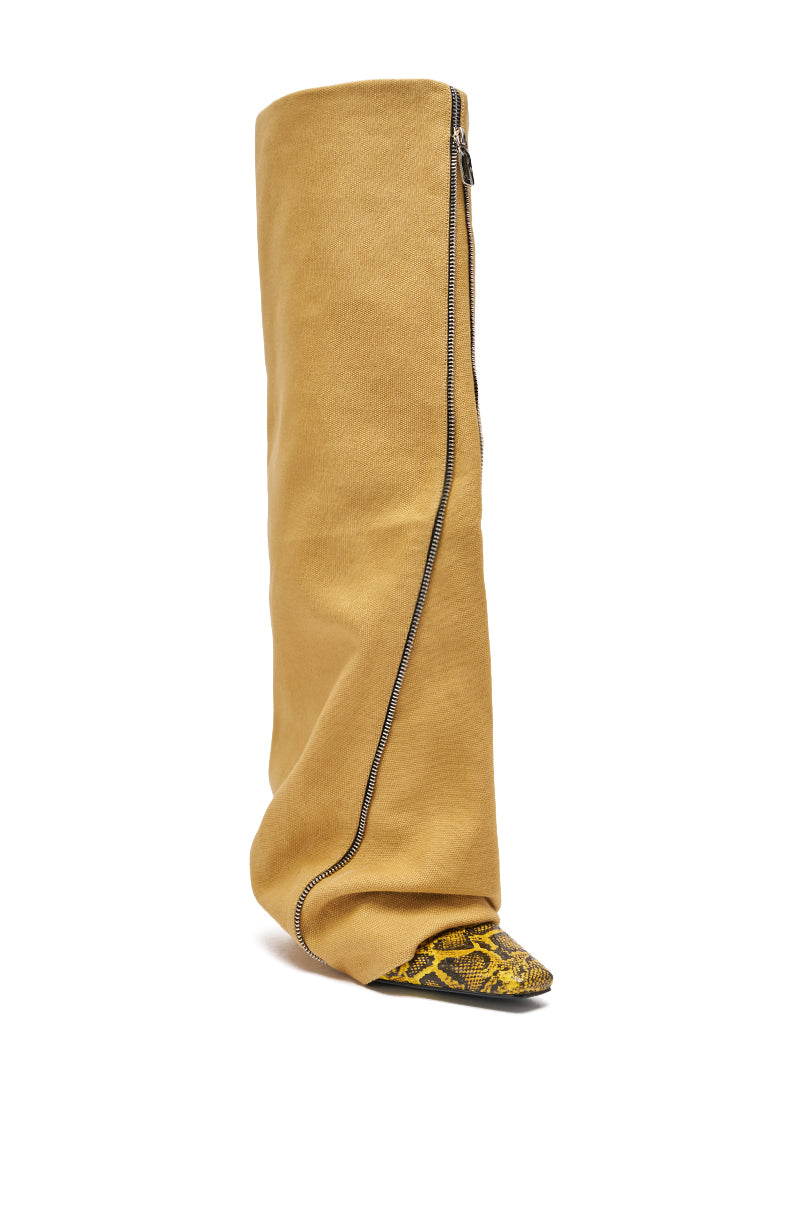 The AKIRA Gold Rashawn Khaki and Snake Boot is a tall, loose-fitting khaki over-the-knee boot with an asymmetrical black zipper and pointed toe featuring a bold yellow and black snakeskin pattern. 4