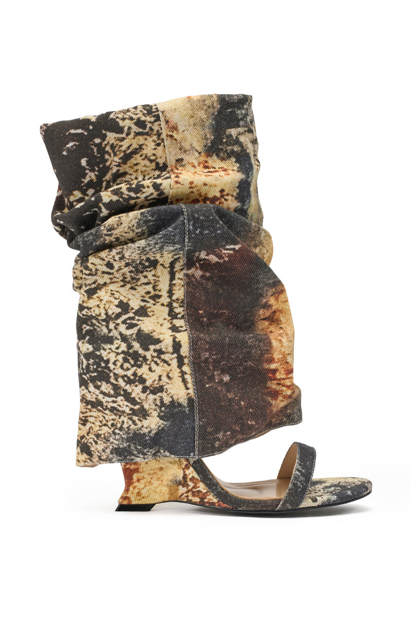 The AZALEA WANG RAXA MULTI OPEN TOE BOOTIE is a single sandal with a flat sole, open toe, and a large, slouchy shaft in textured fabric featuring earthy-toned abstract splatter reminiscent of camouflage. 3