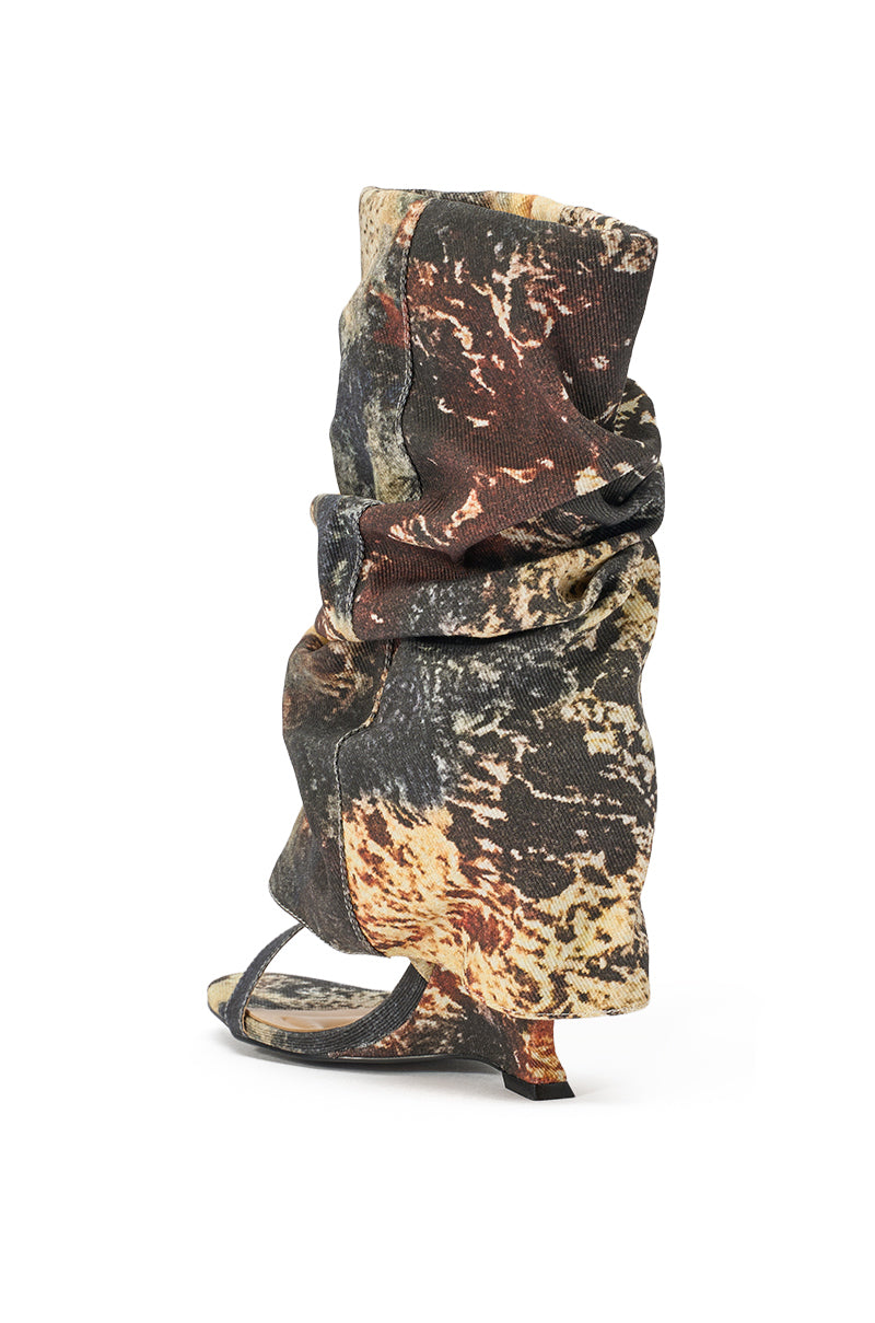 The AZALEA WANG RAXA MULTI OPEN TOE BOOTIE is a high-fashion, slouchy wedge bootie with an abstract marbled pattern in black, brown, beige, and yellow, open toe, small angled heel, displayed on a plain white background. 5