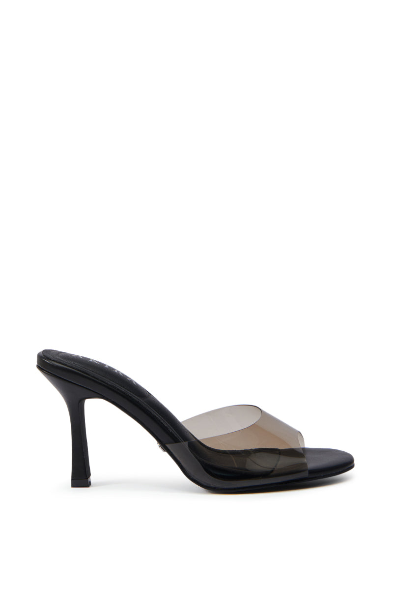 The AKIRA RAYA BLACK PVC CHUNKY HEEL SANDAL is a black mule with a transparent PVC front band and a sleek chunky heel, offering a minimalist, modern look.