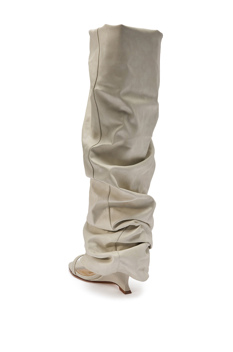 The AZALEA WANG RAYLAN BONE GLADIATOR SANDAL is a tall, slouchy knee-high sandal in light gray with an open toe and low heel, displayed against a white background. 5