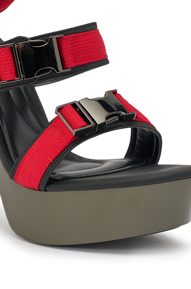 Close-up of the AZALEA WANG RAYLYN Red Platform Chunky Sandal with faux leather red straps, metallic buckles, chunky heel, thick gray sole, black footbed, and a comfort cushion insole. 6