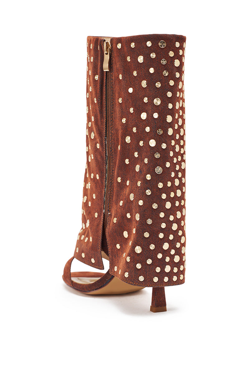 Back view of the AKIRA GOLD RAYSSA burnt orange stiletto sandal featuring a mid-calf height, open toe, zipper closure, and gold hardware embellishments. 5