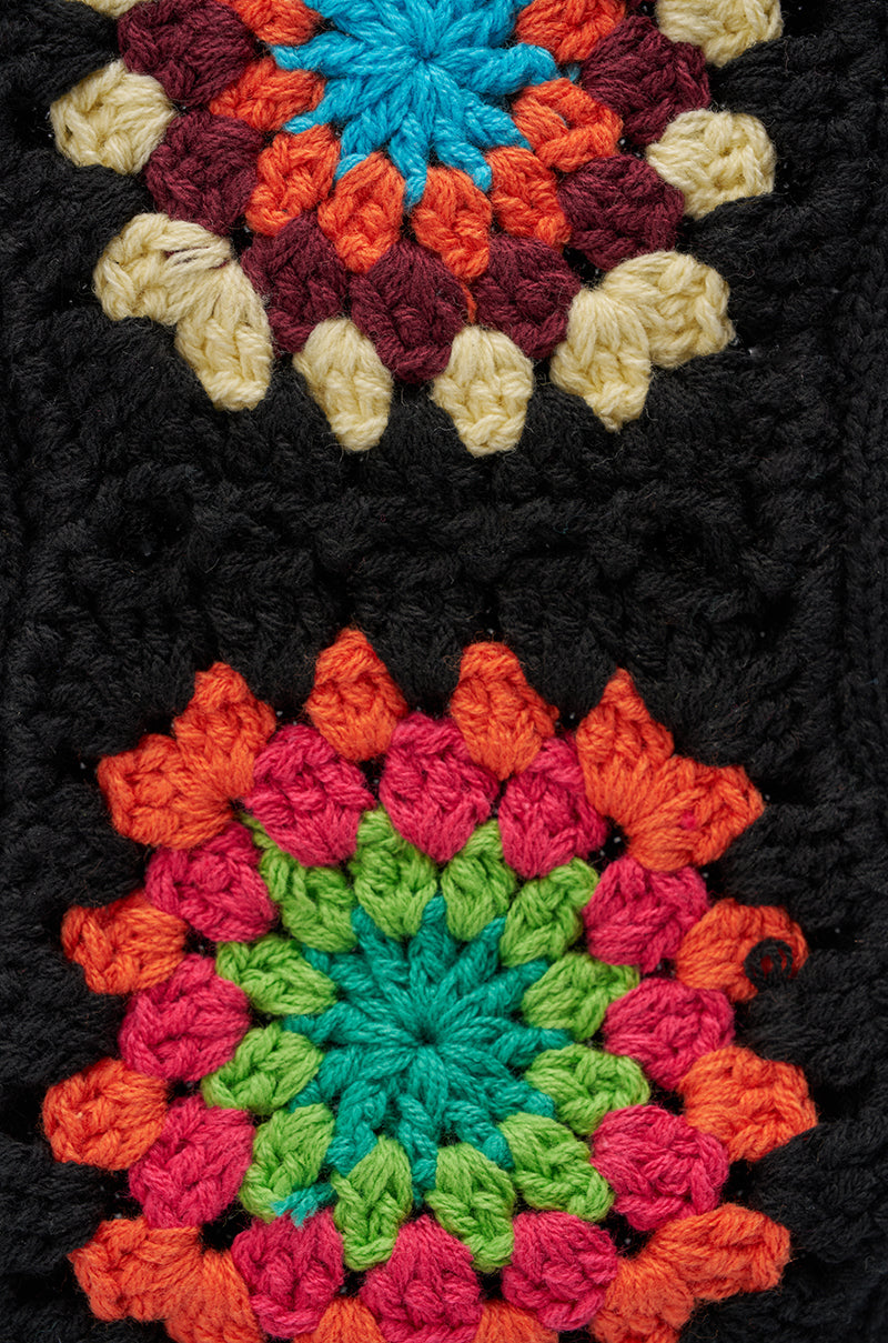 Close-up of TO THE BEACH SOCKS, showcasing vibrant rainbow crochet granny square patterns against black, with bold, geometric textured design for a visually striking look. 3