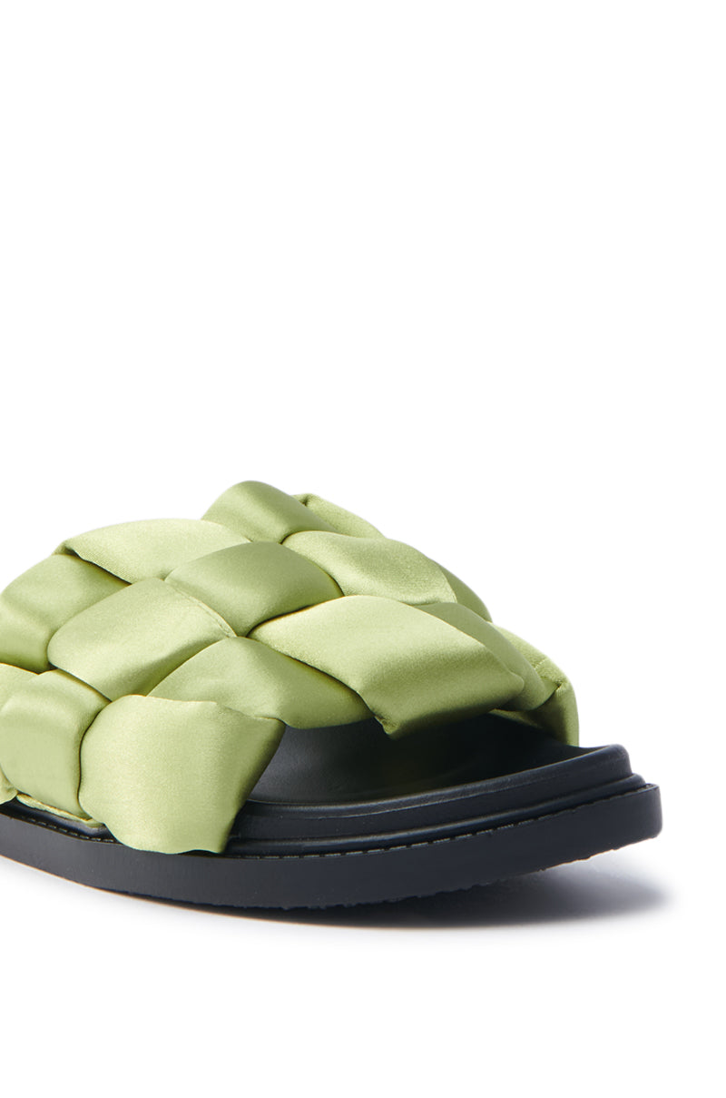 The AKIRA REIGNS OLIVE BRAIDED PUFF SLIP ON SANDAL features an open-toed design with a bright green woven satin upper and flat black sole, blending casual style with bold color.