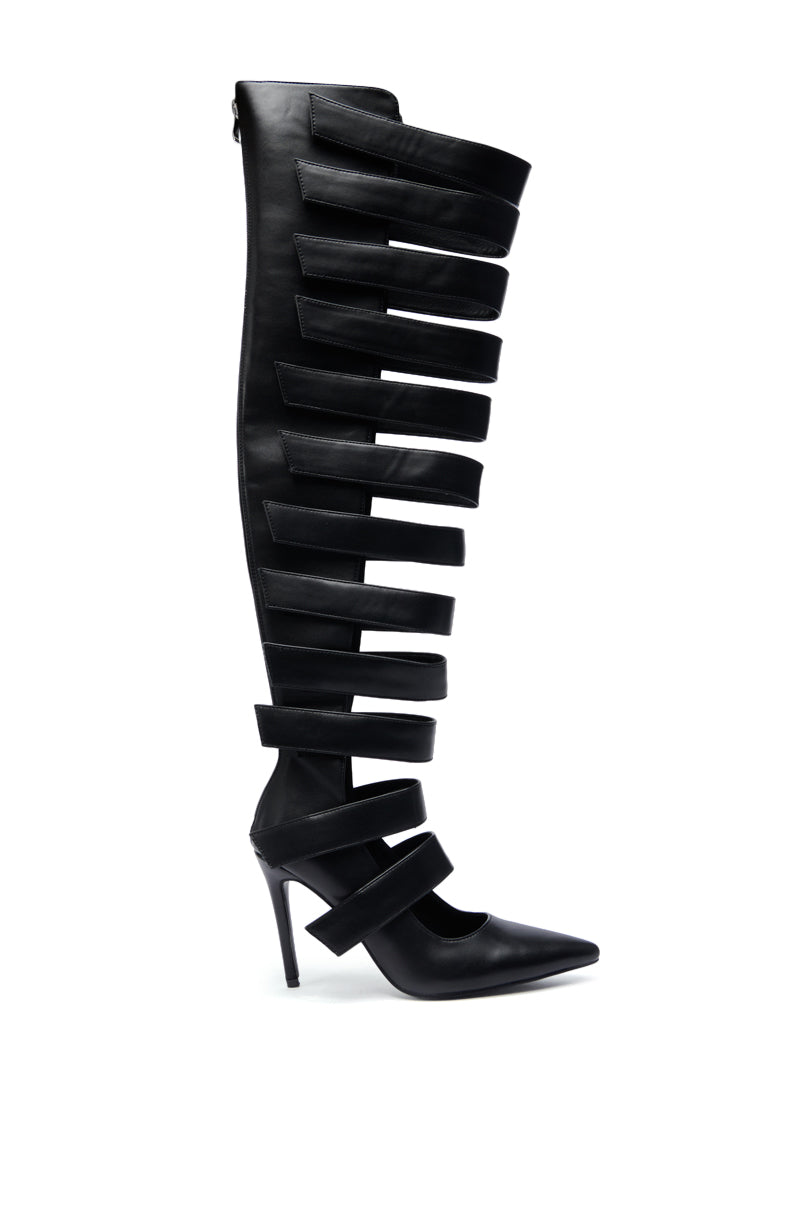 The AZALEA WANG REIN BLACK THIGH HIGH BOOT features a bold, modern look with a stiletto heel, multiple horizontal straps, open sections, and a striking knee-high design.
