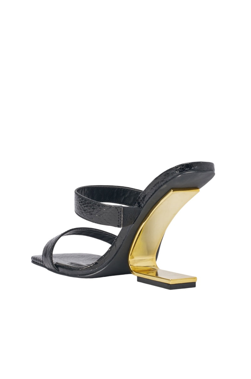 The AZALEA WANG RENIX BLACK SNAKE WEDGE MULE SANDAL showcases two luxe faux leather straps, a sculptural inward-curving wedge heel, and a flat square base for modern elegance. 6