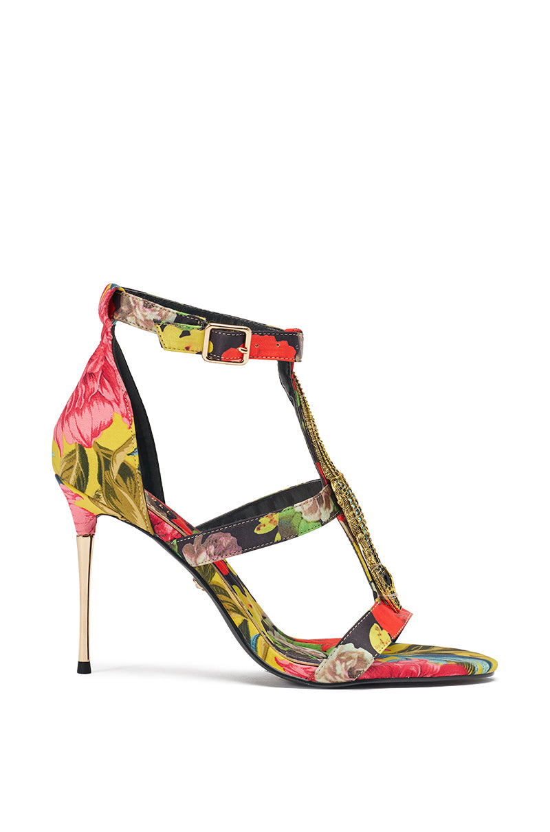 Step boldly into summer with the AKIRA GOLD REPTILIAN MULTISATIN STRAP STILETTO SANDAL, featuring a vibrant tropical-inspired print, thin satin straps, gold buckle, and slender stiletto heel. 5