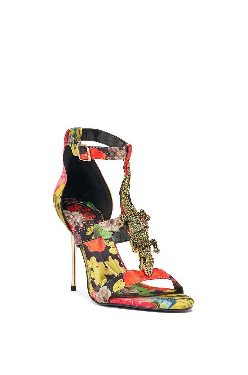 The AKIRA GOLD REPTILIAN MULTISATIN STRAP STILETTO SANDAL features a slender metallic heel, vibrant tropical satin straps, an ankle strap, and a decorative beaded lizard with rhinestone embellishments along the front. 6