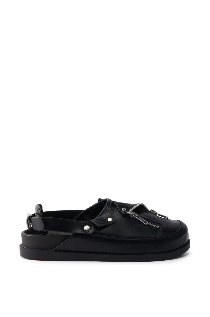 The AZALEA WANG RESTER BLACK HARDWARE EMBELLISHED MULE is a black faux leather mule featuring a closed toe, decorative laces, metallic zipper details, thick flat sole, open heel, and a supportive back strap.