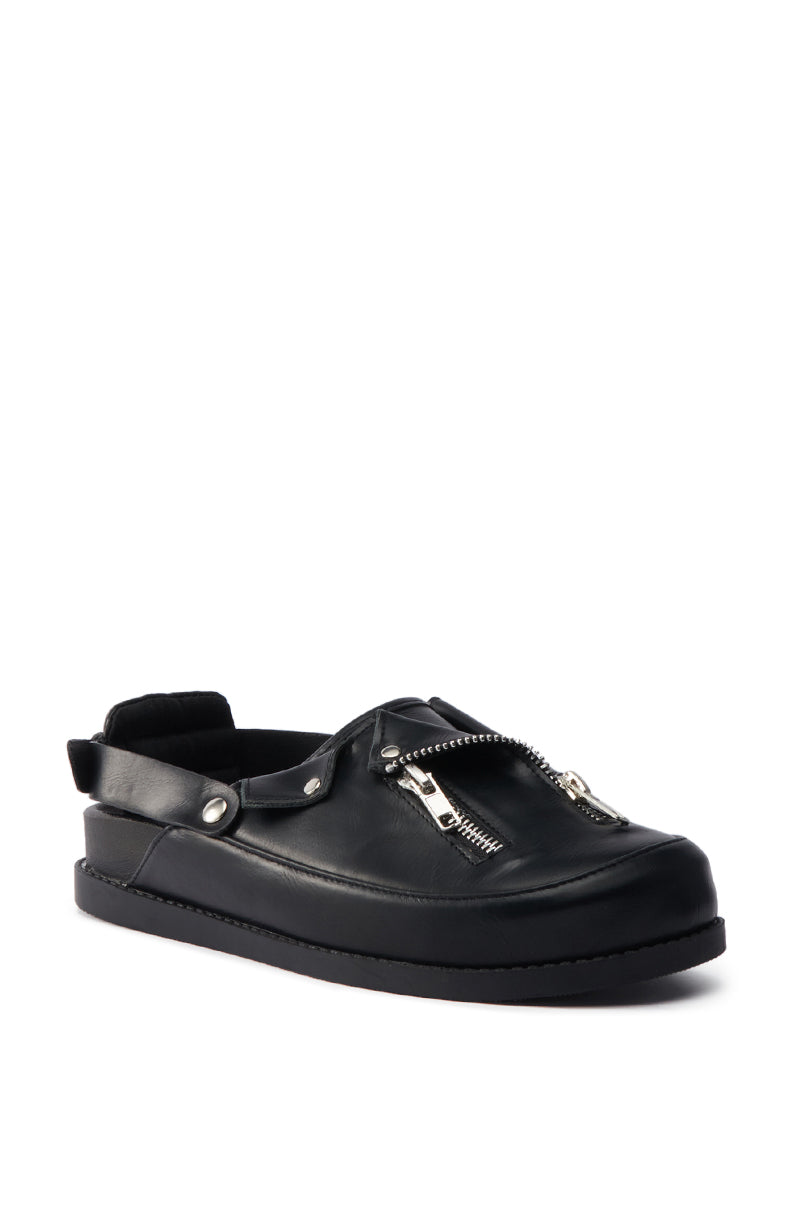 The AZALEA WANG RESTER BLACK HARDWARE EMBELLISHED MULE is a black faux leather slide featuring an open heel, flat sole, and bold metallic zipper detailing across the top.