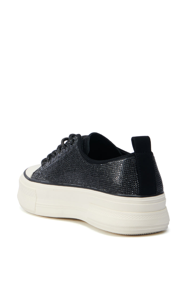 The AZALEA WANG REVIVAL BLACK RHINESTONE FLATFORM SNEAKER is adorned with a glittery finish, features thick white flatform soles, and is viewed from the back. This stylish shoe highlights a faux leather upper, black laces, a pull tab, and a rounded toe.