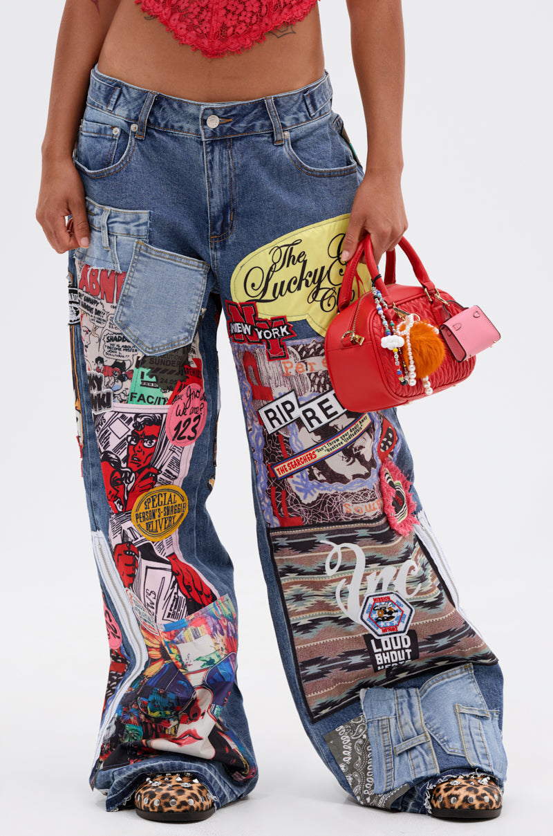 Wearing SO SICK PATCHWORK OVERSIZED JEANS with colorful graphics, this look features a small red handbag with keychains, leopard print shoes, and a red crochet crop top.