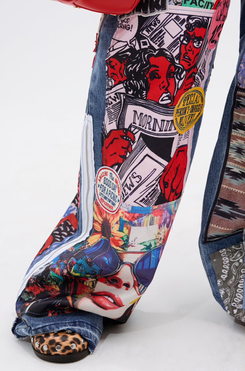 Close-up of SO SICK PATCHWORK OVERSIZED JEANS featuring colorful comic-style patches—faces, newspapers, and text—paired with animal print shoes. The wearer stands on a white surface, highlighting vivid graphic details on the denim.