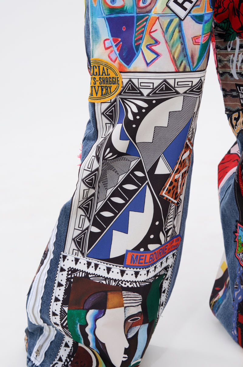 A close-up of the SO SICK PATCHWORK OVERSIZED JEANS, featuring an oversized fit and decorated with colorful patches, bold graphic designs, geometric patterns, text, and stylized faces on denim.