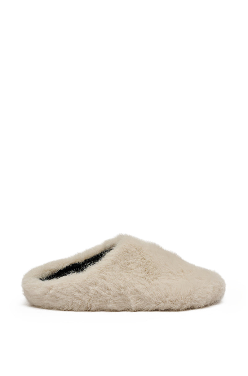 The AKIRA RHYS IVORY FUZZY FLAT, a single beige plush slipper with a low back, is displayed in profile against a plain white background.