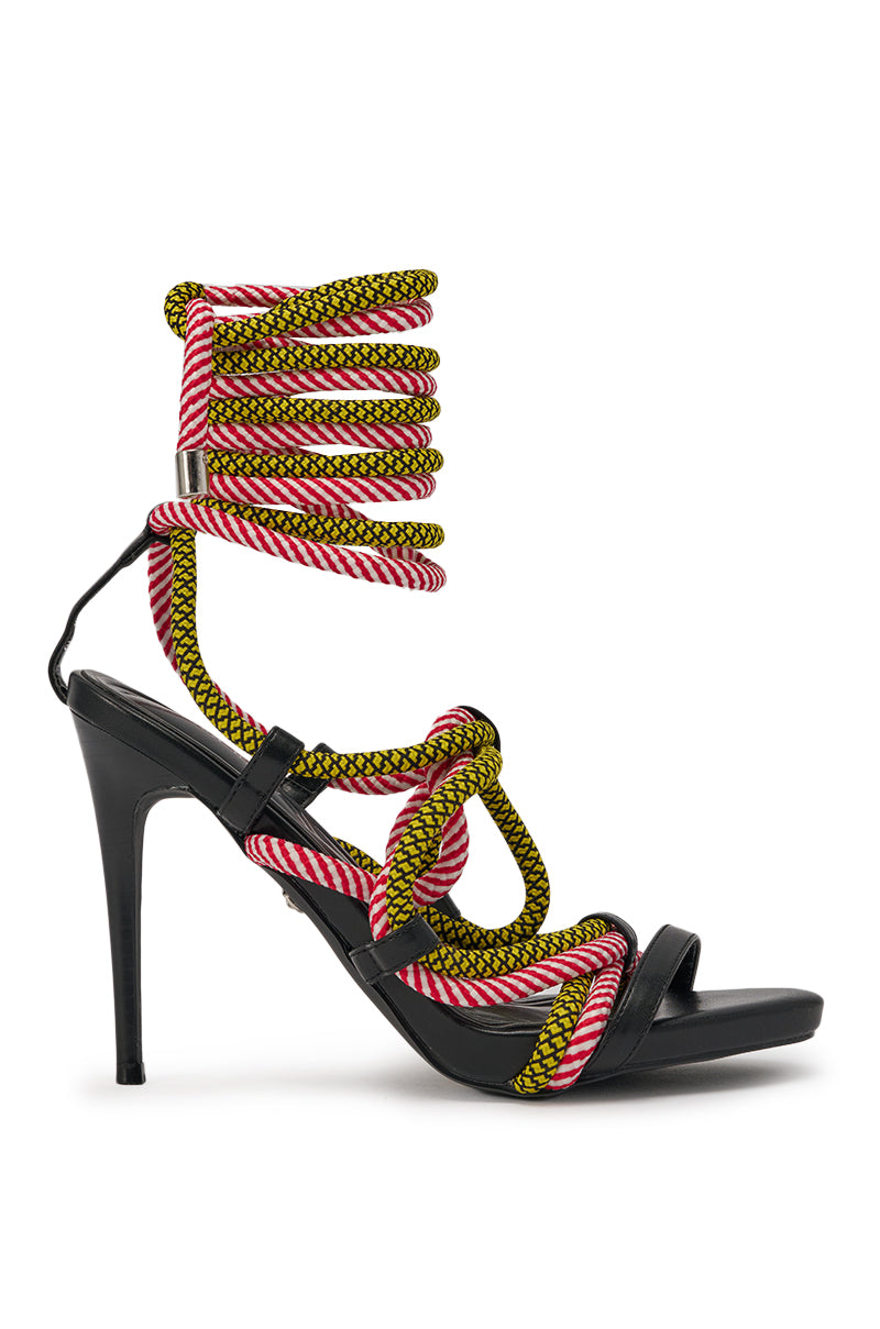 The AZALEA WANG RIJN ROPE STILETTO LACE UP SANDAL features a black high heel and colorful pink, white, and yellow rope laces that wrap intricately around the foot and ankle for a bold, strappy look. 2