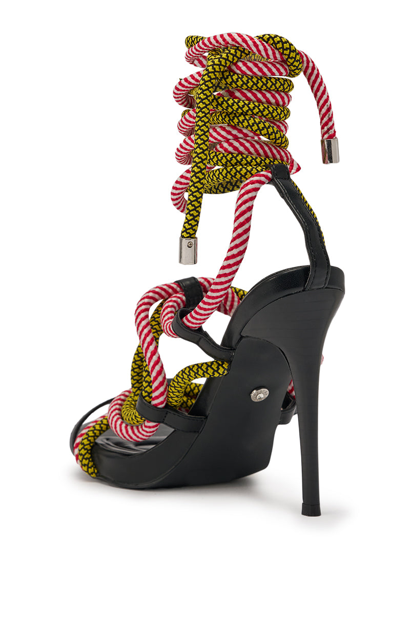 The AZALEA WANG RIJN ROPE STILETTO LACE UP SANDAL features a black faux leather heel and bold yellow-and-black, red-and-white ropes that lace up and wrap elegantly around the ankle for a striking look. 5
