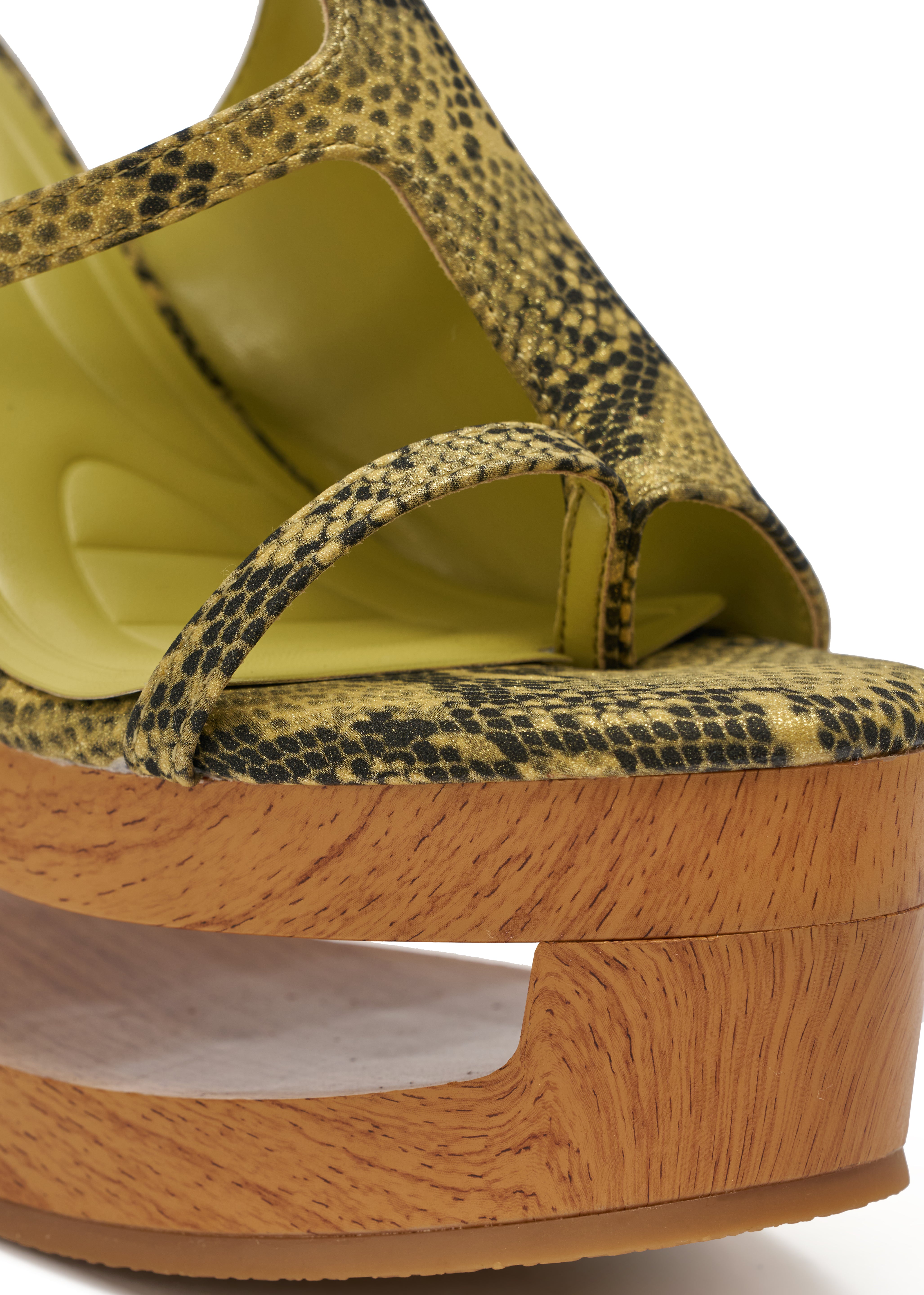 A close-up of the AKIRA GOLD RIN GREENSNAKE NOVELTY LACE UP WEDGE SANDAL, a yellow-green snake-print open-toe wedge with a thick wooden platform heel and stylish cut-out detail. 8