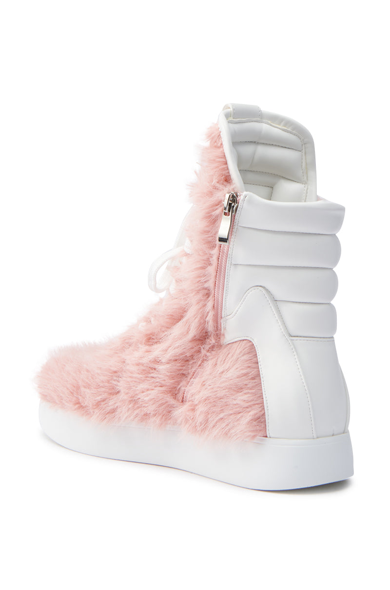 The AZALEA WANG RIORDAN PINK FUR HIGHTOP SNEAKER offers a stylish design with chic pink faux fur, a white sole, and padded heel. It features a convenient side zipper for easy wear.