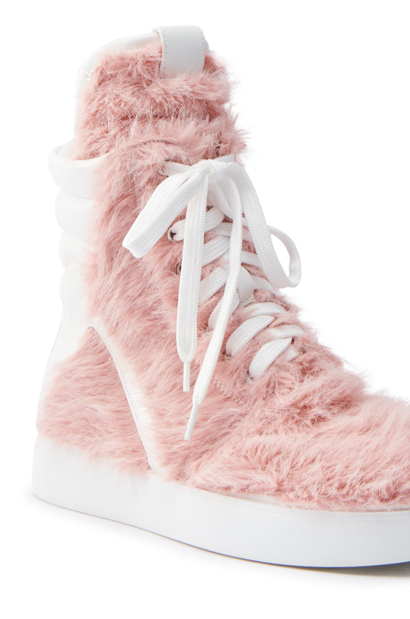 The AZALEA WANG RIORDAN PINK FUR HIGHTOP SNEAKER is elegantly adorned with pink faux fur, white laces, and a sleek white sole. Its unique texture adds a fashionable and playful vibe, making it a standout in any collection.