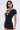 A woman with a sleek black bob and cat-eye glasses wears the LAUREN SEAMLESS ROMPER WITH LACE—made from stretchy fabric with lace trim—standing confidently against a plain light background.