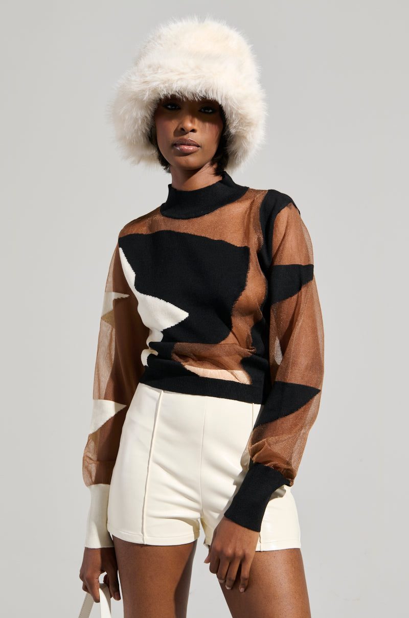 Wearing a BABY PLEASE MESH PANEL BLACK AND WHITE TOP, a person stands confidently against a plain background, sporting white high-waisted shorts and carrying a small bag. Completing their modern and chic look is a fur hat with an abstract colorblock pattern on the mesh top.
