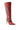 The AZALEA WANG RODRIGO RED BOOT STILETTO is a knee-high, fashion-forward boot with dark maroon accents, ribbed shaft detailing, pointed toe, and high stiletto heel, set against a crisp white background.