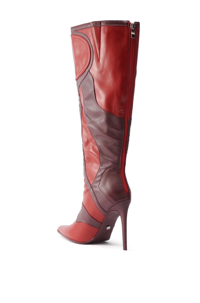 The AZALEA WANG RODRIGO RED BOOT STILETTO is a knee-high, fashion-forward design with panel detailing and side zipper, displayed in bold red and maroon tones on a white background.