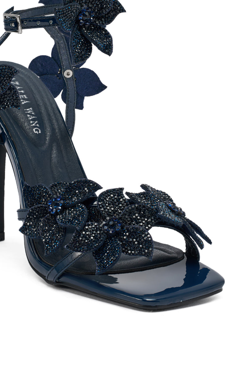 The AZALEA WANG ROMI Rhinestone Embellished Navy Dressy Sandal features sparkling rhinestones on the strap and ankle, a glossy square toe, and a chic stiletto heel for a standout look.