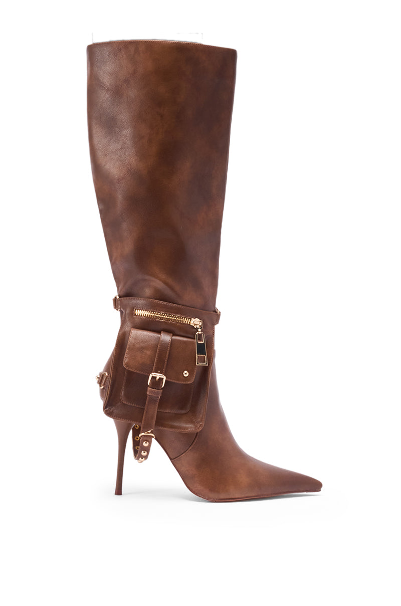 The AZALEA WANG RONDEL BROWN DISTRESSED STILETTO BOOT features brown leather, knee-high design, pointed toe, gold zipper, and side pocket with buckle detailing.