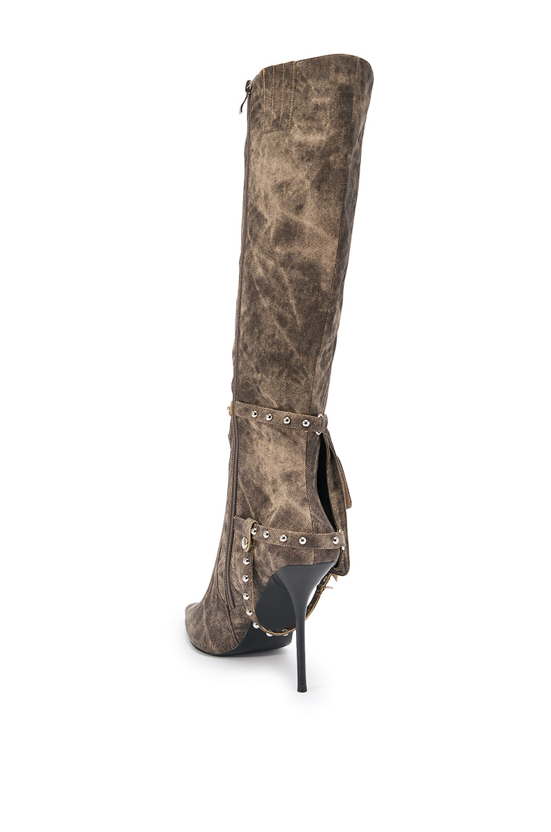 The AZALEA WANG RONDEL BROWN MULTI DISTRESSED STILETTO BOOT, a brown knee-high boot with a pointed toe, decorative straps, and metal studs, is shown from the back on a white background. 5