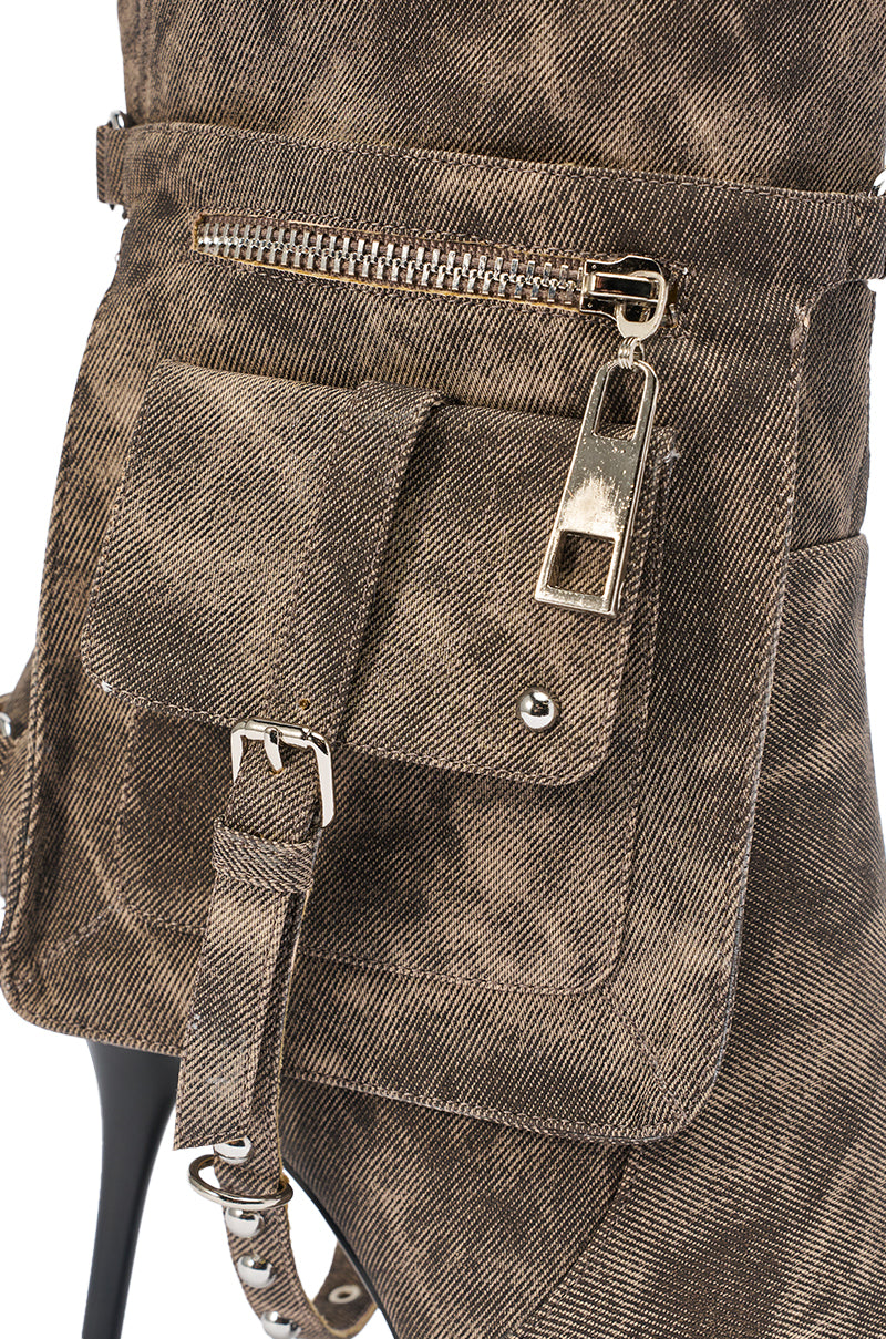 Close-up of the AZALEA WANG RONDEL BROWN MULTI DISTRESSED STILETTO BOOT, showcasing its brown textured faux leather, metallic zippered pocket, flap pocket, and a stylish decorative strap with buckle. 6