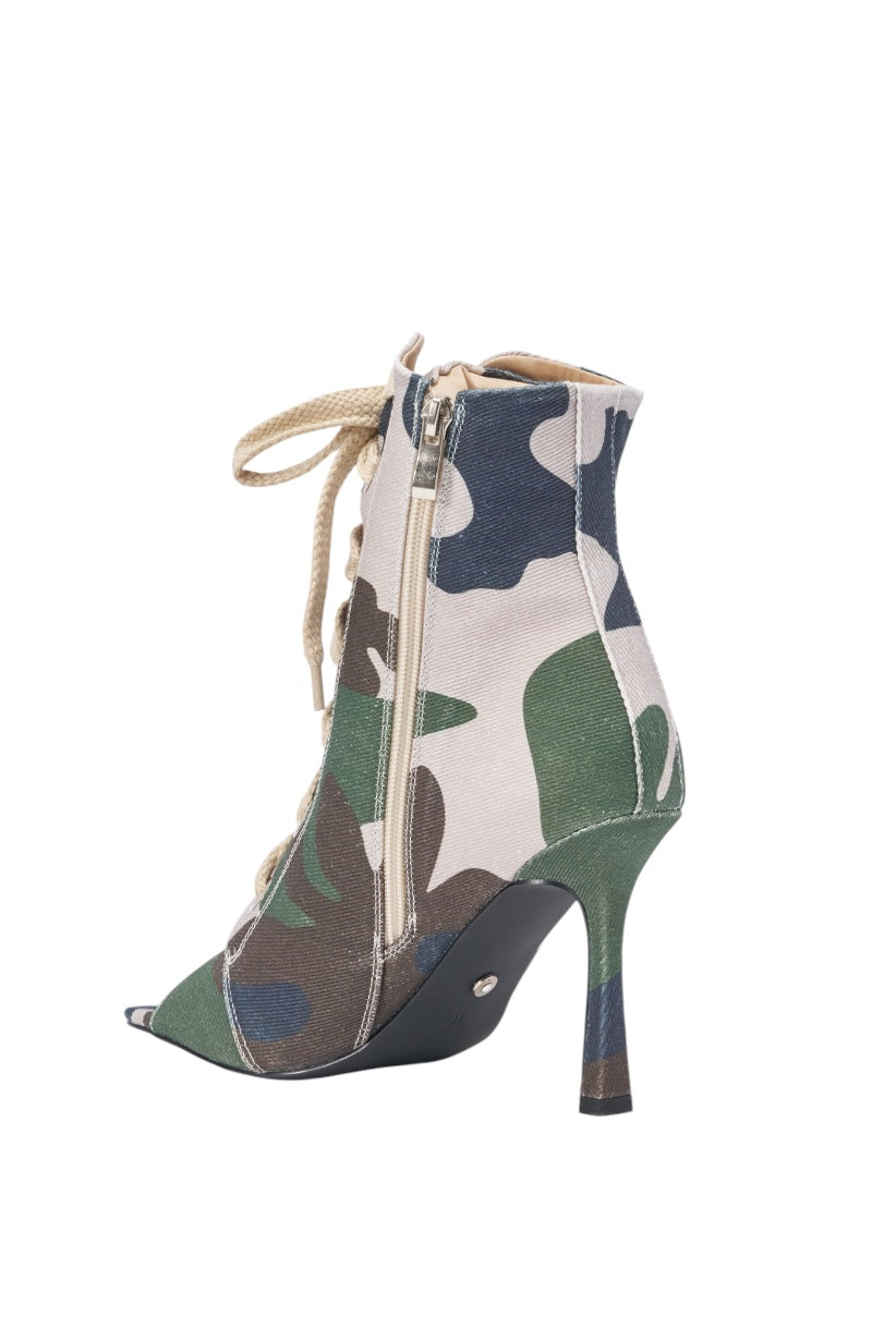 The AZALEA WANG ROOFTOP CAMO OPEN TOE LACE UP BOOTIE showcases a bold camouflage print, open toe, lace-up front, and side zipper, styled as a stiletto ankle boot against a white background. 5