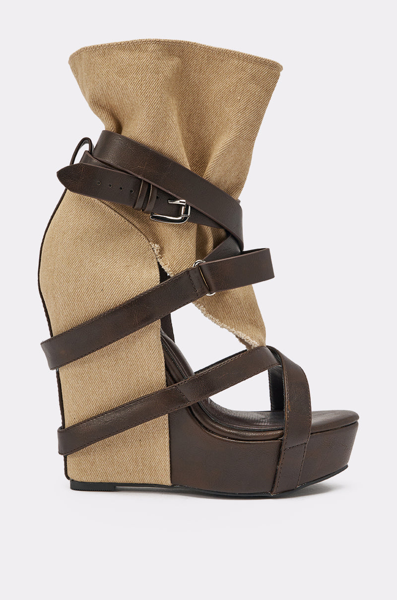 The AZALEA WANG ROTHKO WEDGE SANDAL IN BROWN TAUPE features a high-heeled platform, brown leather straps, a tan canvas-like upper with fold and buckle ankle detail, sculptural design, and cushioned insole for all-day comfort. 3