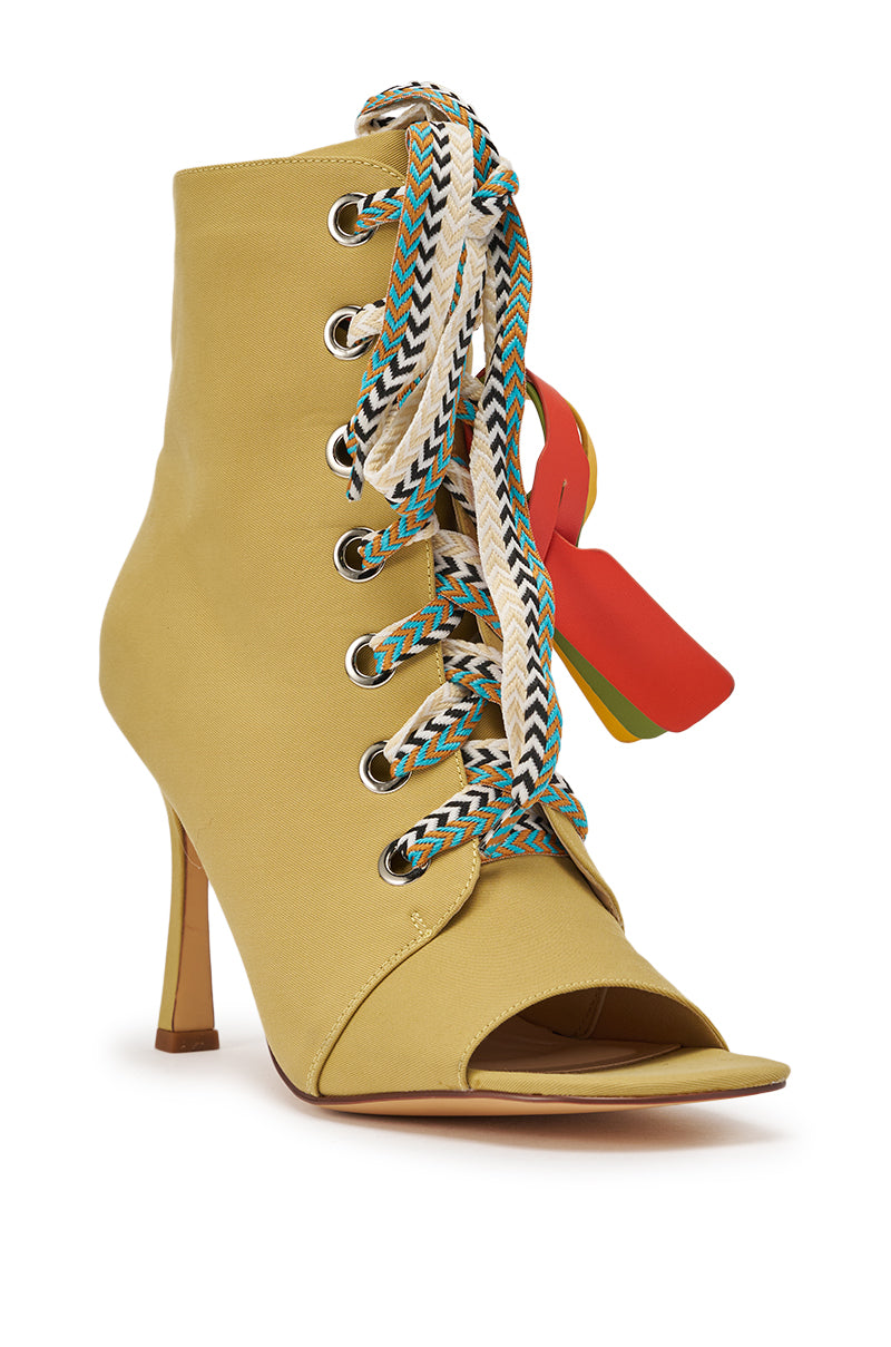 The AZALEA WANG ROVEA KHAKI LACE UP STILETTO BOOTIE features an open toe, large silver eyelets, colorful patterned laces, and red, yellow, and green tags near the top for a bold statement. 6