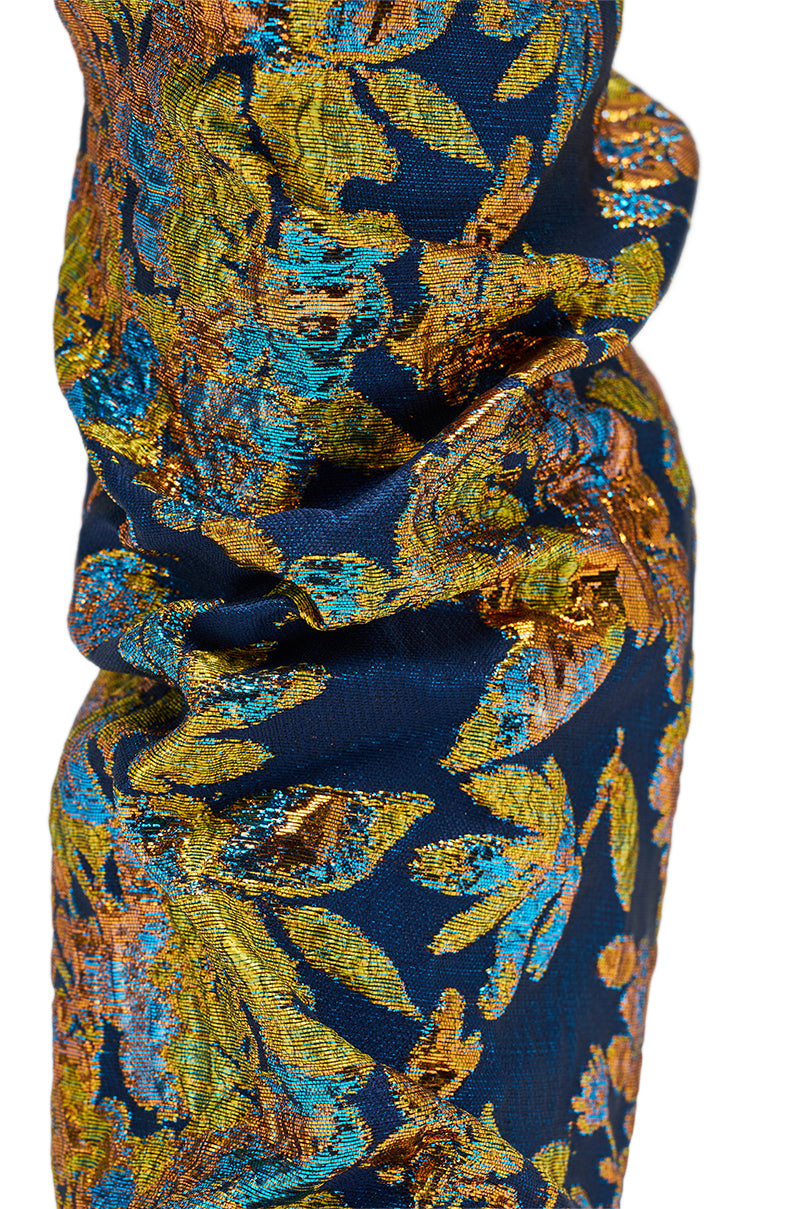 Close-up of the AZALEA ROZSI BLUE MULTI BROCADE OPEN TOE STILETTO BOOTIE, showcasing richly textured fabric with intricate gold, blue, and green metallic floral patterns on a dark base, reminiscent of ruched metallic brocade.