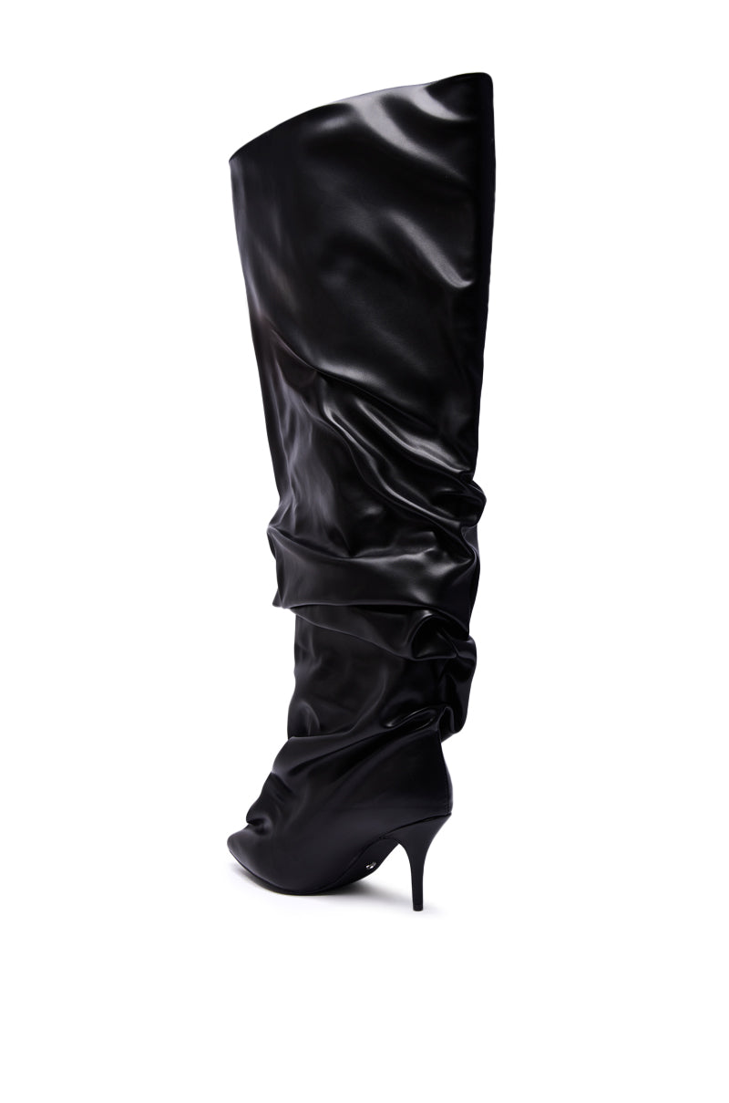 The AZALEA WANG RUBIUS BLACK EXTREME RUCHED BOOT is a single pointed-toe stiletto boot in glossy black faux leather with dramatic ruching, shown against a white background.