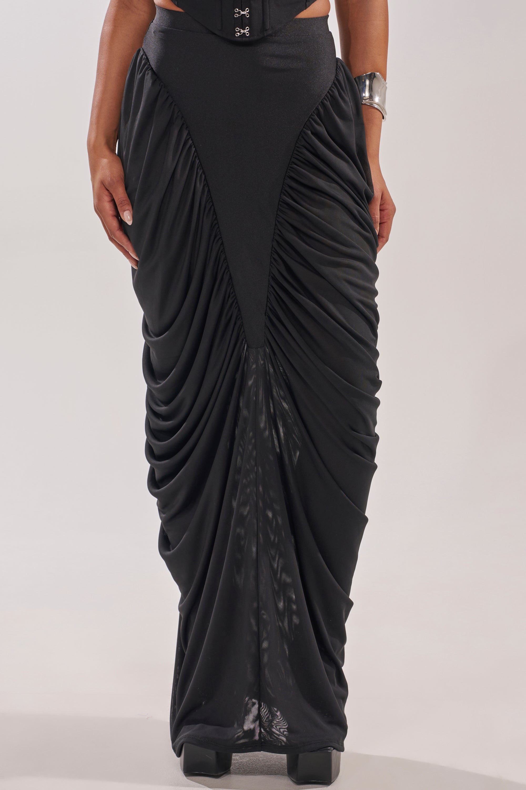 A person models the DREAMY RUCHED SKIRT, featuring draped sides and a high-rise waistband. Only their lower body is shown against a light background. 2