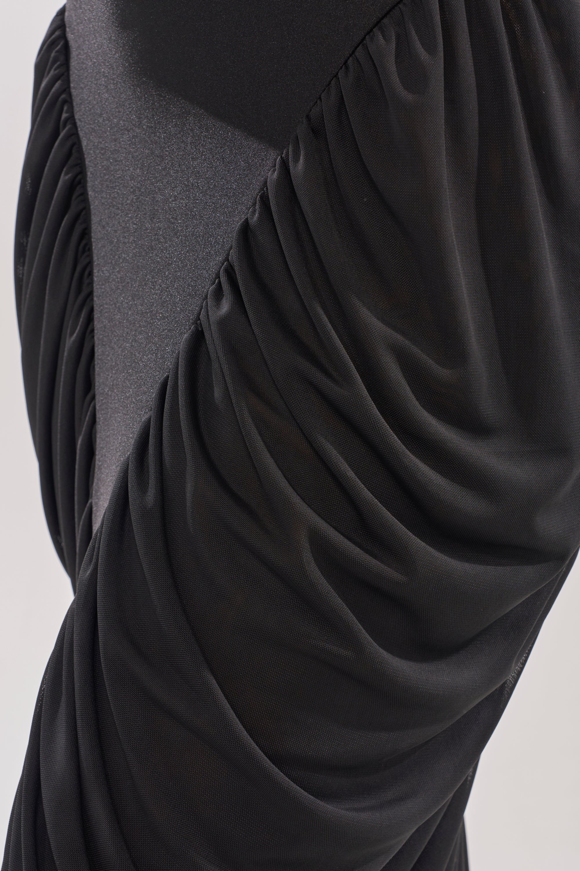 Close-up of the DREAMY RUCHED SKIRT, showcasing ruched black mesh diagonally layered over a solid matte base for a textured, draped effect. 7