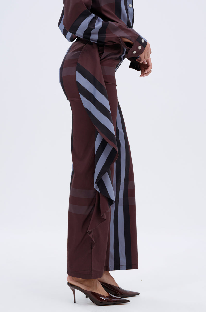 A person wears the maroon and navy LUXURY LIFE PLAID PALAZZO PANT with ruffle details, a matching top, and pointed maroon heels, standing against a plain white background.